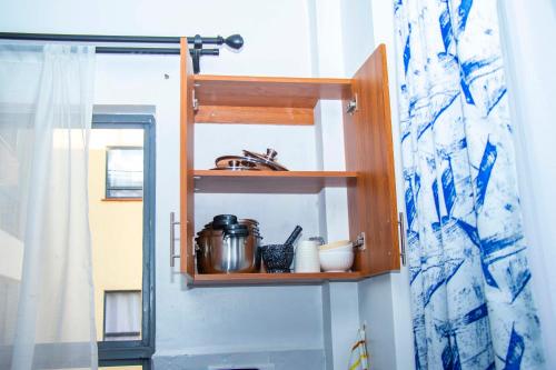 a kitchen with a shelf and a sink in a room at Adristar Homes Ruiru Membley in Ruiru