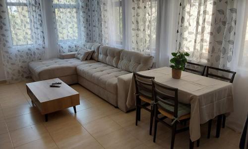 a living room with a couch and a table at Etara 2 Apartment in Sveti Vlas
