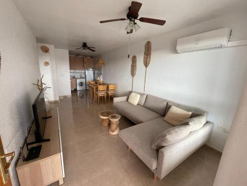 a living room with a couch and a ceiling fan at Bol02 - Modern 2 bedroom apartment in Bolnuevo in Bolnuevo