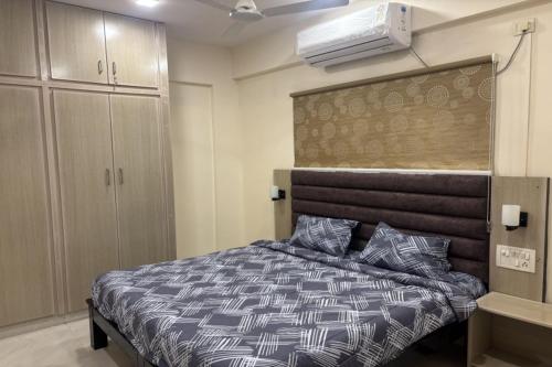 a bedroom with a bed and a closet and a heater at Abhayaa Stays in Visakhapatnam