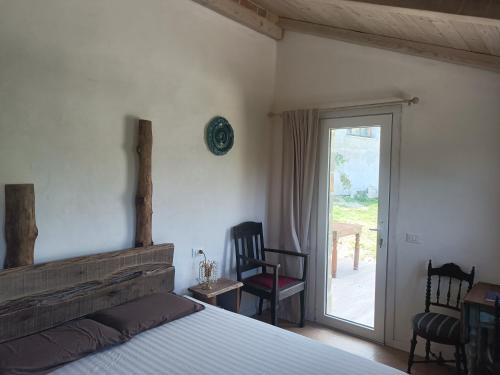 a bedroom with a bed and a door to a patio at B&b da Elena e Davide in San Donato in Taviglione