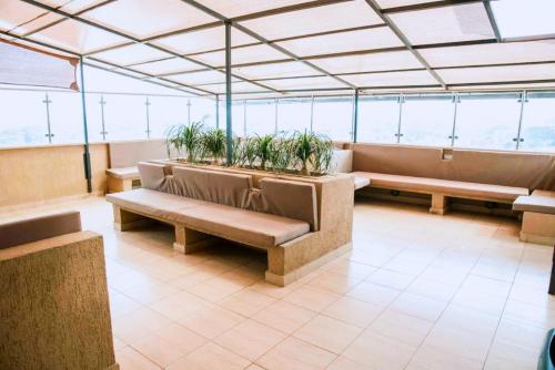 a waiting room with benches and potted plants at Urban Vibes Getaways - Premium Westlands Nairobi Apartment with Luxury Amenities in Nairobi