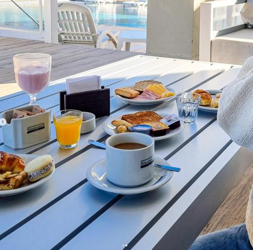 a table with breakfast foods and a cup of coffee at StradivariuS Hotel Boutique in Villa General Belgrano