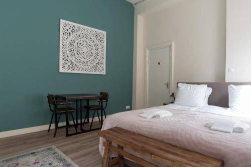 a bedroom with a large bed and a table with chairs at 1001 Nights Boutique Lofts in Haarlem