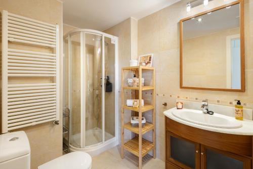 a bathroom with a sink and a shower and a toilet at Duplex Las Margas Vistas Montañas in Sabiñánigo