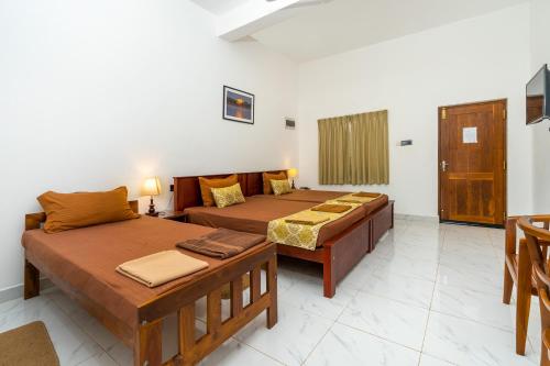 Katil atau katil-katil dalam bilik di Mailagama Cinnamon Residence