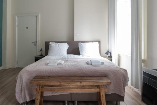 a bedroom with a large bed with two towels on it at 1001 Nights Boutique Lofts in Haarlem