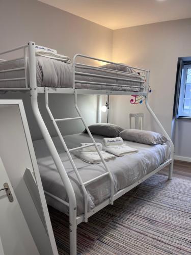 a bedroom with a bunk bed in a room at Perquilhas House in Freixial do Campo