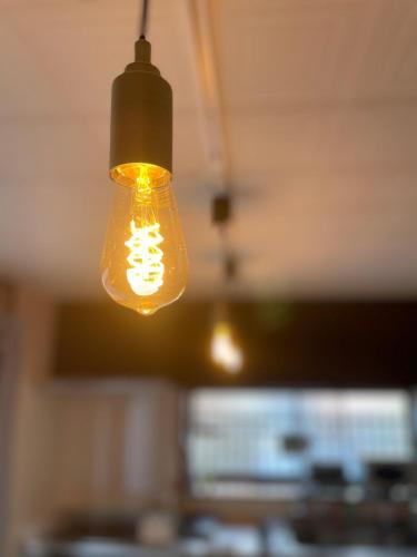 a light bulb hanging from a ceiling in a kitchen at KYOTO TANGO MIYAZU inn in Miyazu