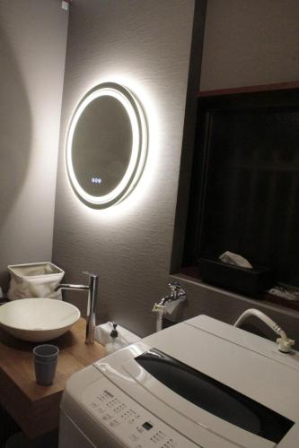 a bathroom with a sink and a washing machine at KYOTO TANGO MIYAZU inn in Miyazu