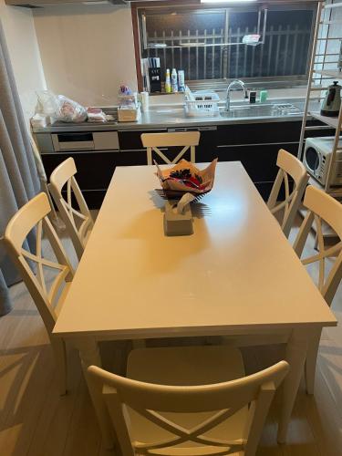 a table and chairs in a kitchen with a counter at KYOTO TANGO MIYAZU inn in Miyazu