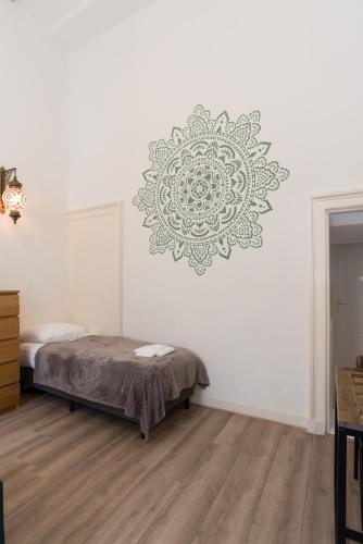 a bedroom with a bed and a mandala on the wall at 1001 Nights Boutique Lofts in Haarlem