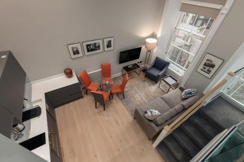 an overhead view of a living room with a couch and chairs at Destiny Scotland George IV Apartments in Edinburgh