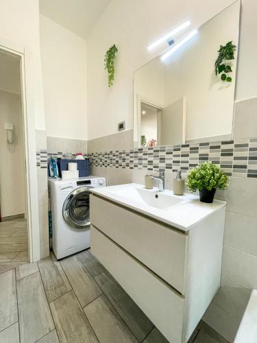 a bathroom with a sink and a washing machine at Home In Town - Fiera Milano City near San Siro Stadium metropolitana M1 - M5 in Milan