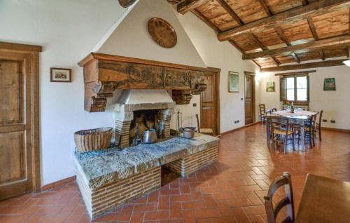 a living room with a brick fireplace in a house at Nice Home In Pratovecchio Stia in Borgo alla Collina