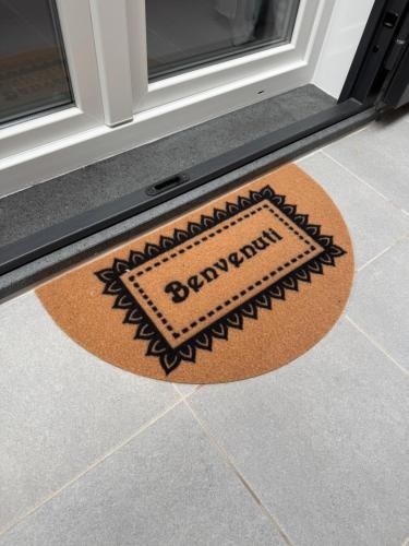 a welcome mat in front of a door at A tre passi dal mare in Agropoli