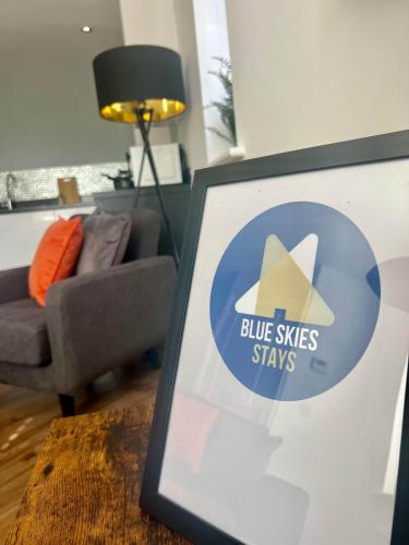 a picture of a living room with a blue skies stays sign at Swan House in Pallion