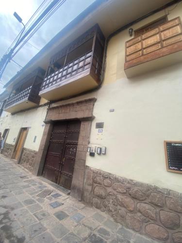 a building with two balconies on the side of it at Casa Cusco Centro in Cusco