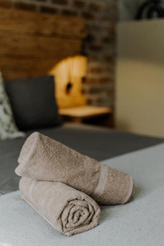 a rolled up towel sitting on top of a bed at Afri Villa Stays - Luxury Bush Villa Bird in Marloth Park