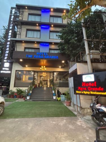 a hotel with a sign in front of a building at Hotel Agra Grande By Goyal Hoteliers in Agra