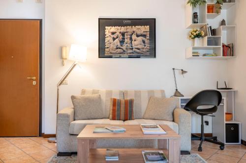 a living room with a couch and a table at L'angolo di Anna in Pieve di Soligo