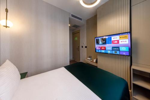 a room with a bed and a flat screen tv at THE NEST HOTEL in Istanbul