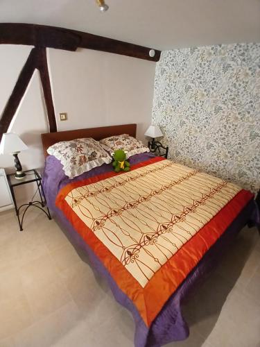 a bedroom with a bed with a flower on it at La CRAPOUNETTE in Pierry