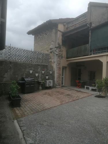 an outdoor patio of a house with a grill at Allegra22 in Sale Marasino