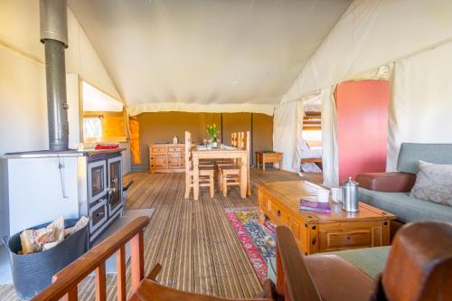 a living room and dining room in a tent at Skylark - Sweffling Hall in Rendham
