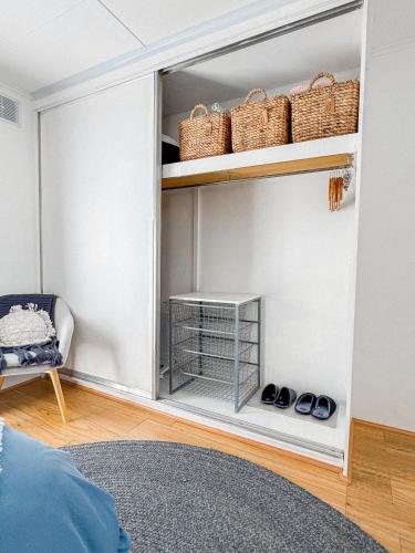 a room with a closet with baskets and shoes at Bayside Bungalow in Frankston