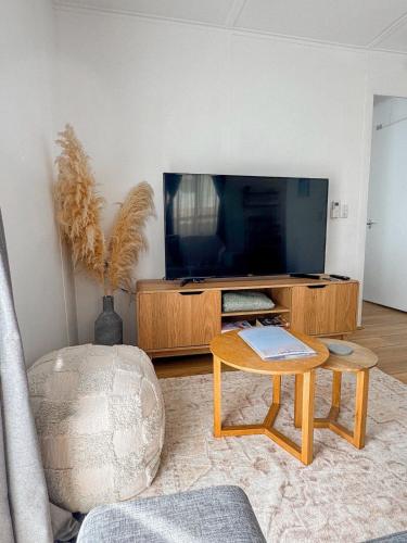 a living room with a tv and a coffee table at Bayside Bungalow in Frankston