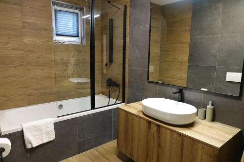 a bathroom with a white sink and a shower at Adorable Holiday Apartment in Malinska