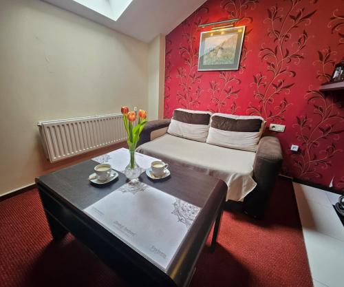a hotel room with a bed and a table with flowers at Euphoria Residence in Sosnowiec