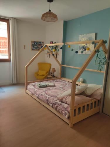 a bedroom with a bed with a wooden frame at Au coeur de la vieille ville, Chambre privée indépendante in Sommières