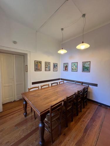 a large room with a wooden table and chairs at B&B Villa Mirandola in Brunate