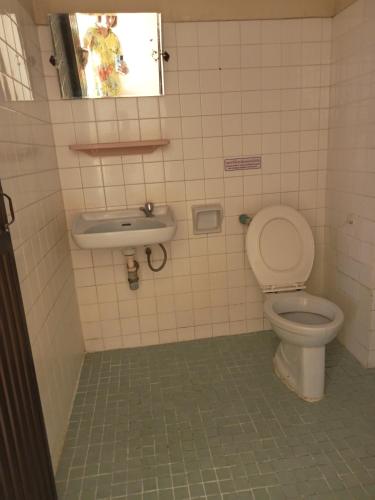 a bathroom with a toilet and a sink at Suksabai Hotel Phuket in Phuket