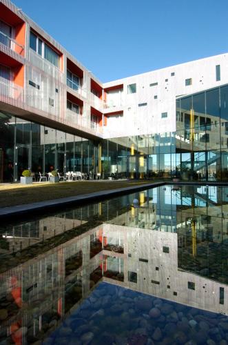 a building with a pool of water in front of it at LOISIUM Wine & Spa Hotel Langenlois in Langenlois