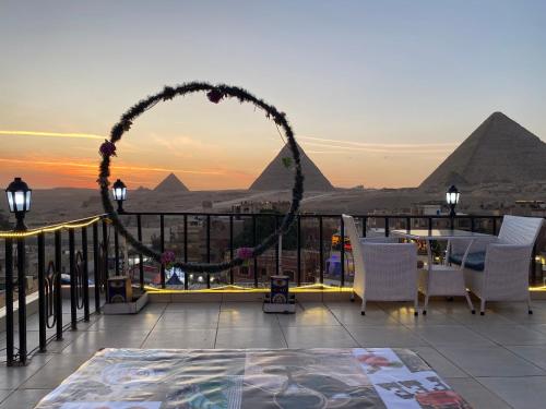 a view of the pyramids from a balcony with a wedding arch at Golden Pyramids View Inn in Cairo
