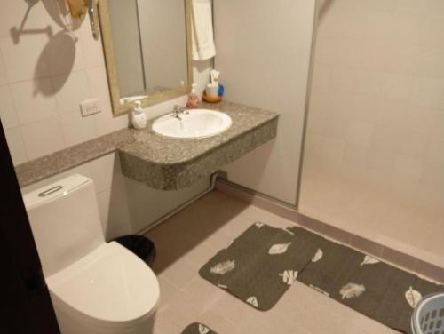 a bathroom with a toilet and a sink at Waterfront Royal Villa in Bang Pakong