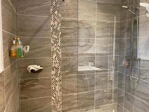 a bathroom with a shower with a glass door at Atlantic Bliss in Portstewart