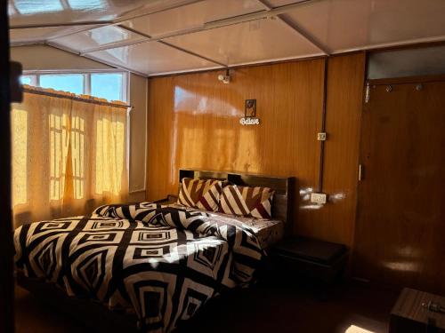a bedroom with a zebra print bed in a room at Nani House the mall road shimla in Shimla