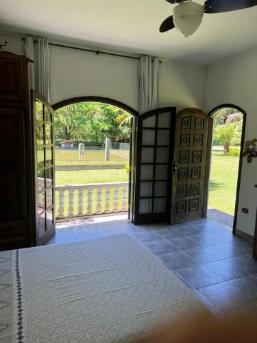 an entrance to a house with an open door at Sítio Roselaine - Dream Place in Jacareí