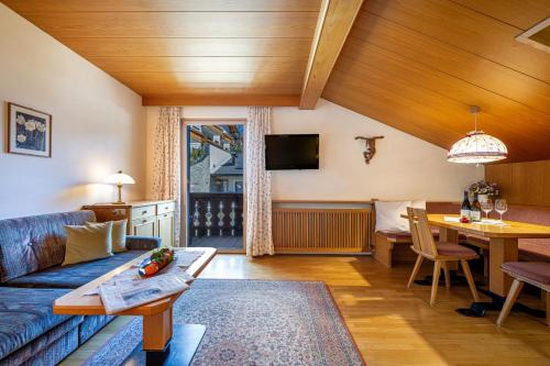 a living room with a couch and a table at Panorama Apartments Walter in Ortisei