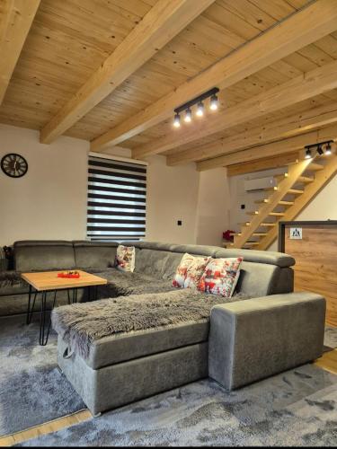 a living room with a couch and a table at Villa Pine in Lukavac