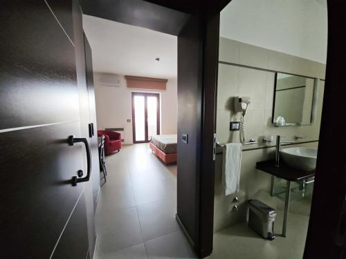 a room with a bathroom with a sink and a mirror at Rooms affittacamere in Lioni
