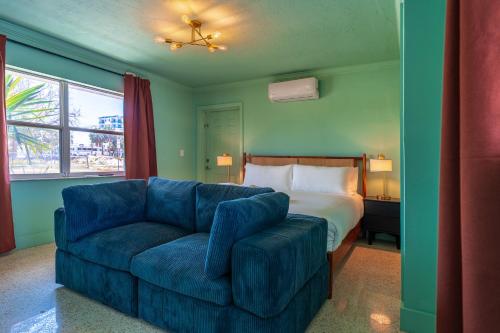 a living room with a couch and a bed at Monaco Vacation Rentals in Clearwater Beach