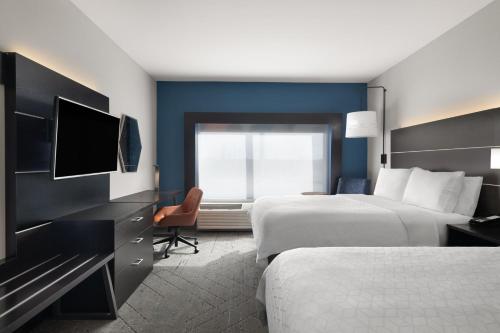 a hotel room with two beds and a television at Holiday Inn Express & Suites West Memphis by IHG in West Memphis