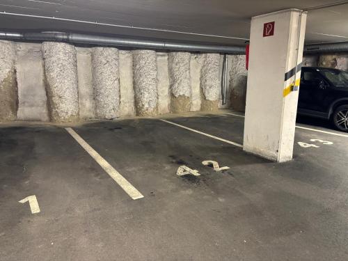 a parking garage with a car parked in it at Apartment Klagenfurt Center with Free Parking - RING41 in Klagenfurt