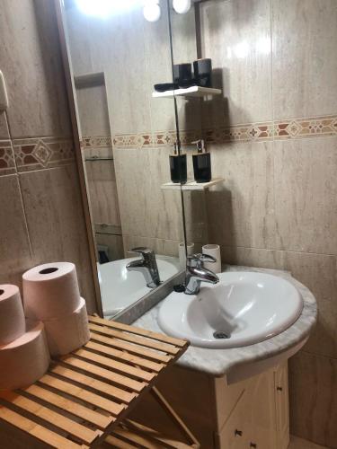 a bathroom with a sink and a mirror at la bella de plaza mayor in Madrid