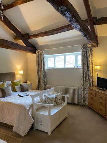 a bedroom with a white bed and a window at The Punch Bowl Inn in Kendal